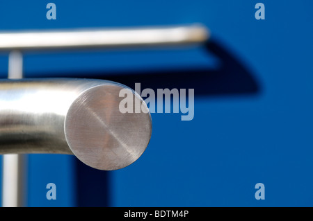 Abstract pattern of curved shadow from handrail on wall Stock Photo