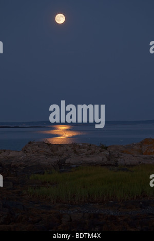 Full moon rising over the ocean on Bailey Island Stock Photo