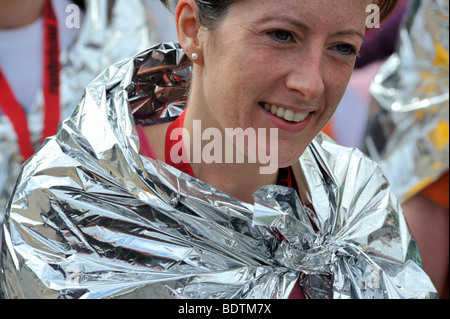 Young woman runner in foil wrap after Bristol Half Marathon, UK Stock Photo
