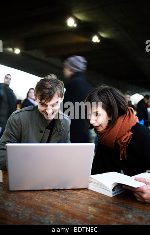 A couple in London using a laptop Stock Photo