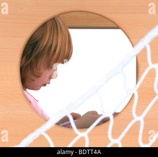 child playing in a Billi-Bolli loft bed Stock Photo