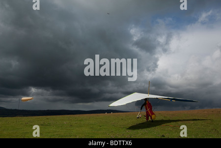 hang glider preparing for take off into stormy sky Stock Photo