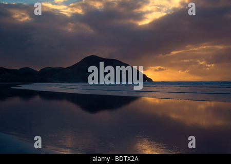 luminous landscape, amazing light display sunbeams beach sunset, Wharariki Beach, Golden Bay, New Zealand,  South Island, Nelson Stock Photo