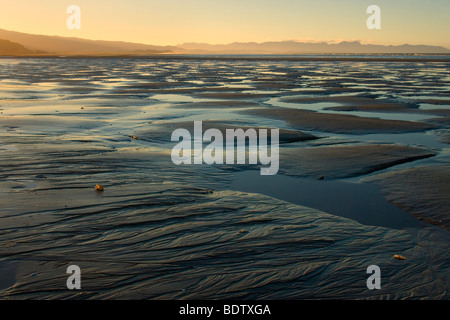 Pohara Beach, sky reflected in water gathering between sand ripples, Pohara, Golden Bay,  Tasman District, New Zealand Stock Photo