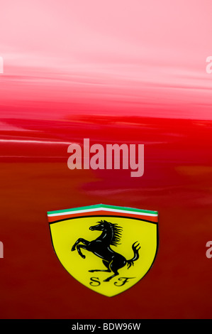 Close up of a Ferrari logo of the 'prancing Horse' on a yellow shield,  against a red background Stock Photo - Alamy