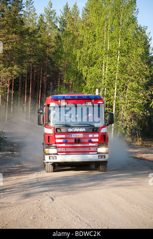Finnish fire truck at forest road , Finland