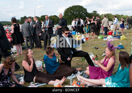 Man showing off to group of women having fun on day out in the Silver Ring enclosure at Ascot races, England, UK Stock Photo