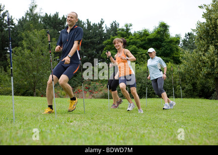 A personal trainer and three women on the obstacle course in a park Stock Photo