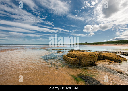 Looking towards Dunstanburgh Castle from Embleton Bay, Northumbria UK Stock Photo