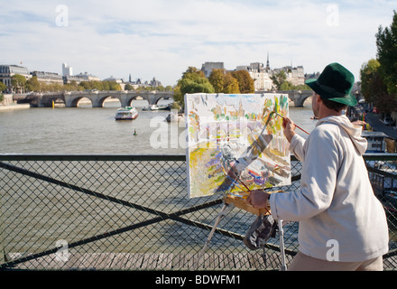 A painter on Pont des Arts in Paris, France Stock Photo