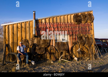 A trapper displays his catch of Beaver, Otter, Muskrat, and Mink. Stock Photo