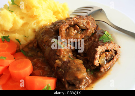 Close-up on a plate of beef olives, boiled carrots and mashed potatoes. Stock Photo