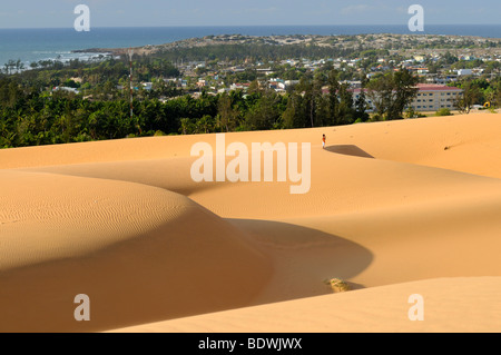 Sand dunes and structures in front of the city of Mui Ne, Red Sand Dunes, Vietnam, Asia Stock Photo