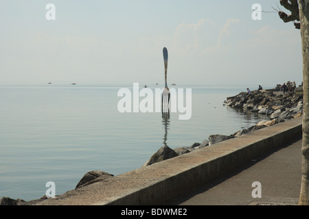 Modern art piece of a table fork in the lake near Vevey Switzerland Stock Photo