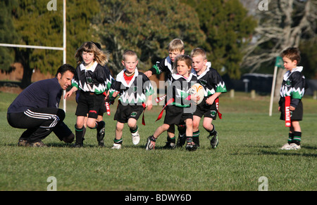 Young girls and boys play rugby union in New Zealand