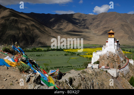 First and oldest fortress of Tibet, Yumbulagang with prayer flags above the Yarlung valley, Central Tibet, Tibet, China, Asia Stock Photo