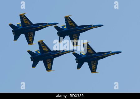 Four members of the US Navy's Blue Angels Demonstration Squadron flying Boeing F/A-18 Hornet fighter jets in tight formation. Stock Photo