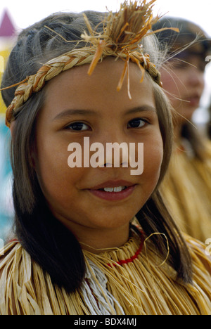 Portrait of Coast Salish Native American Indian Girl wearing Traditional Cedar Bark Costume at Powwow, British Columbia, Canada Stock Photo