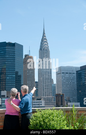Couple Enjoying NYC Skyline from Roof Stock Photo - Alamy