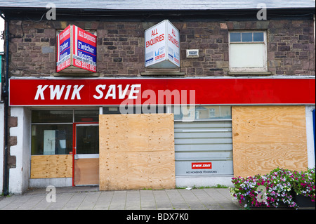 Closed and boarded up KWIK SAVE store on main shopping street in Risca South Wales UK Stock Photo