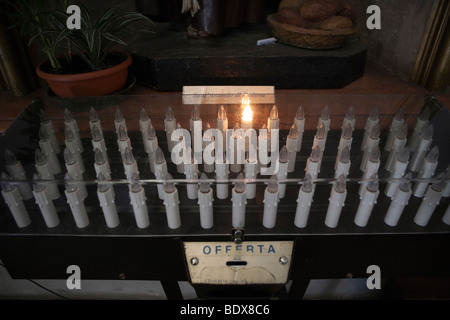 Row of small electric burning candles as offerings in a church, Tuscany, Italy, Europe Stock Photo