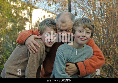 Ten and twelve-year-old boys with their father Stock Photo