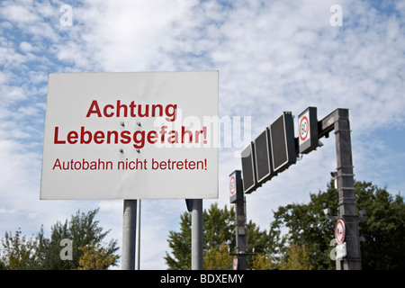 Warning sign on a highway 'Achtung Lebensgefahr! Autobahn nicht betreten!' 'Attention, mortal danger! Do not enter the highway  Stock Photo