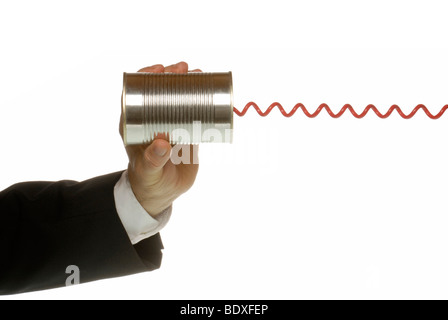 Business man with tin and telephone cable, a symbolic image for communications Stock Photo