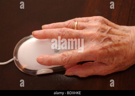 Aged hand with computer mouse