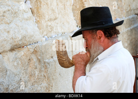 Israel, Old City of Jerusalem, Jew deep in prayer at the Wailing Wall blowing a Shofar Stock Photo