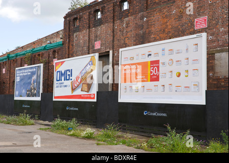 ClearChannel billboard for Halifax KitKat and Sainsburys on side of derelict building in UK Stock Photo