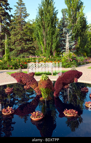 A decorative pool with dolphin sculptures in the English Gardens in Assiniboine Park in Winnipeg, Manitoba, Canada. Stock Photo