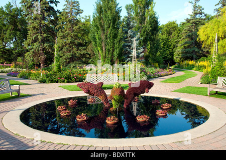 A decorative pool with dolphin sculptures in the English Gardens in Assiniboine Park in Winnipeg, Manitoba, Canada. Stock Photo