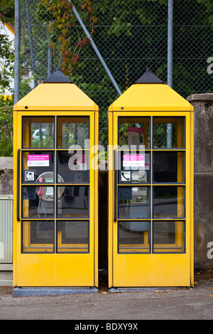 Two yellow telephone kiosks boxes Germany Europe Stock Photo