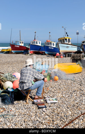 Artist painting on the beach at Beer Devon England Stock Photo