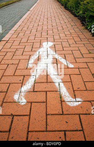 photograph of pedestrian image painted on pavement Stock Photo