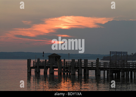 Pier in front of a colorful evening sky at Ammersee lake near Herrsching, Bavaria, Germany, Europe Stock Photo