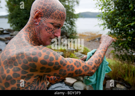 Tom Leppard the 'Leopard Man of Skye' is a hermit and the world's most tattooed man, with tattoos covering over 99% of his body. Stock Photo