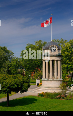 Old City Hall Clock Tower in Victoria Park Kitchener Ontario with Canadian flag Stock Photo