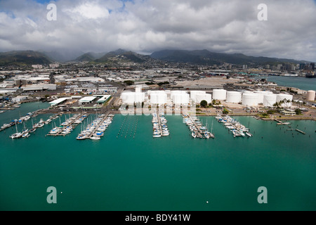 Aerial view of Keehi Small Boat Harbor in Honolulu, Hawaii showing oil storage tanks in background. Stock Photo