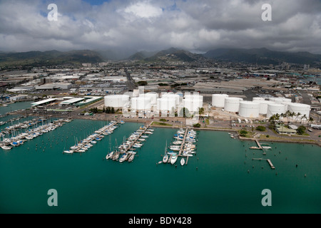 Aerial view of Keehi Small Boat Harbor in Honolulu, Hawaii showing oil storage tanks in background. Stock Photo