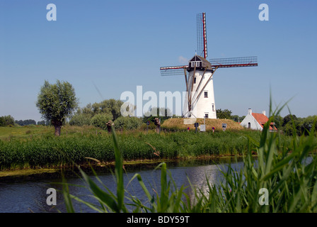 Traditional Windmill by canal in Damme, near Bruges, Belgium. Stock Photo