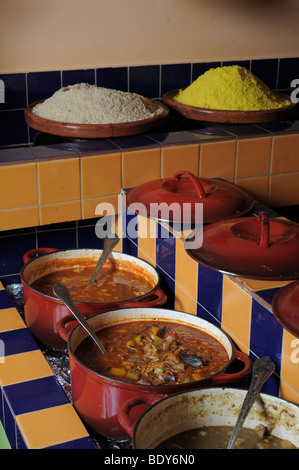 Traditional Moroccan cuisine. Simmering pots of meat and vegetables different varieties of Steamed Cuscus can be seen Stock Photo