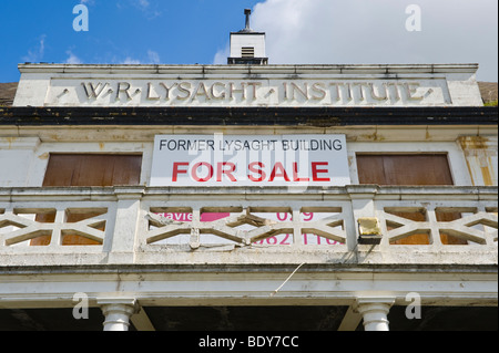 Exterior facade of derelict and for sale boarded up former steelworkers institute in city of Newport South Wales UK Stock Photo