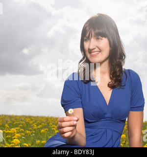 Woman sitting on meadow Stock Photo