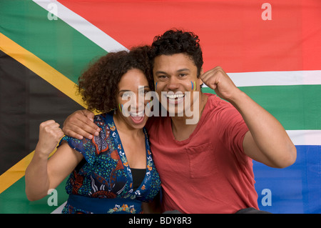 Couple smiling with South African flag Stock Photo