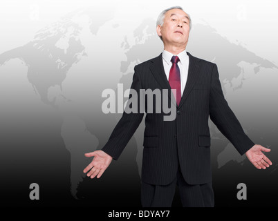 Asian man standing in front of world map Stock Photo