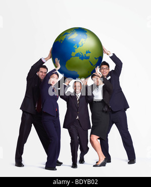 A business group holding up a big globe Stock Photo