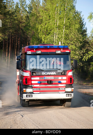 Finnish fire engine driving on a dirt road at countryside , Finland Stock Photo