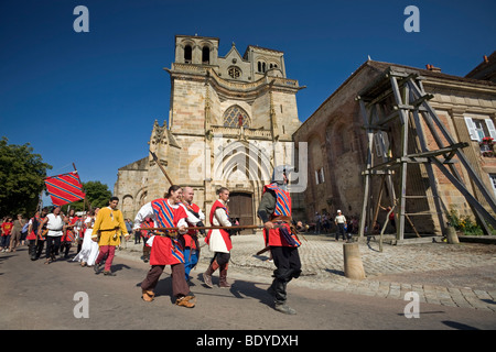A fancy dress procession at the time of the Souvigny Medieval Festival (France). Défilé costumé lors de la Foire de Souvigny. Stock Photo